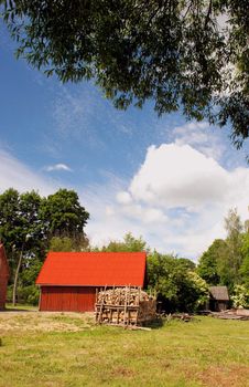 Red roof of the building and firewood