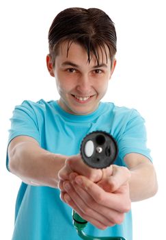 A happy teen boy pointing a garden hose fitted with selective trigger nozzle.  White background.