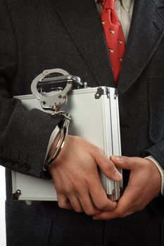 businessman  with a briefcase and handcuffs 