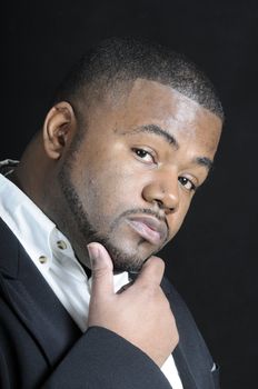 young bearded  African American man in a sports coat and white shirt thinking