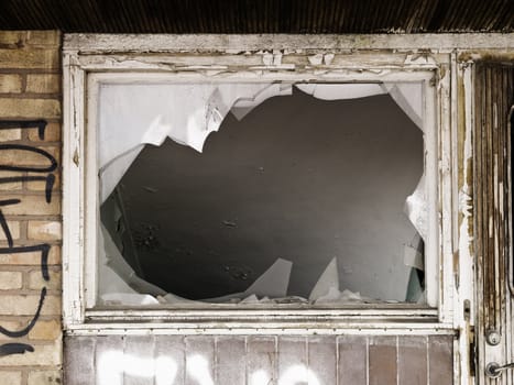 Broken window on a worn building