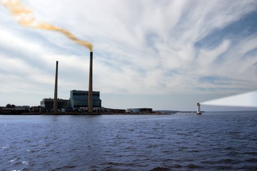 smoke rising from a power generating station with lighthouse beams