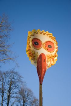 Mardi Gras bird mask on blue sky background