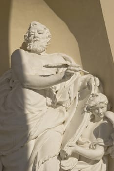 old religiuos sculpture fragment in cathedral nishe – old man and angel