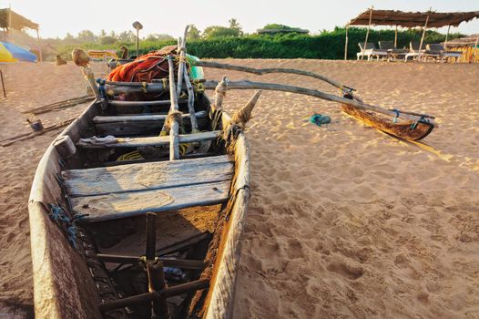 Old wooden fishing boat on the sandy beach