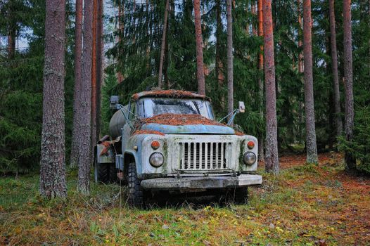 Old tank truck in the coniferous forest