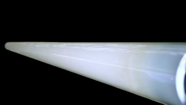 Long luminescent white lamp on a black background