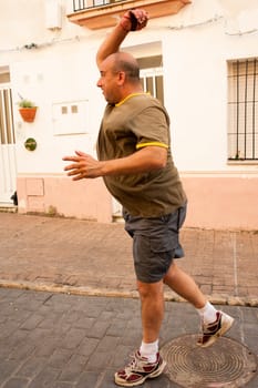 Traditional Spanish pelota player performing a serve