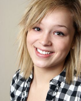 A closeup shot of a happy smiling young woman.