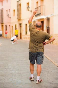 Traditional Spanish pelota player performing a serve