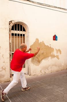 Traditional Spanish pelota player performing a serve