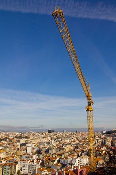 construction crane over ancient Lisbon city centre