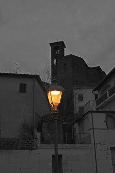 Lit lamp over a white and black view 