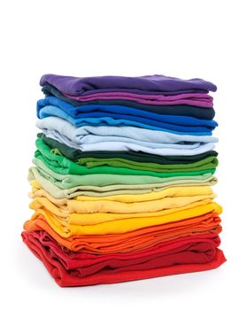 Rainbow clothes pile. Bright folded clothes on white background.