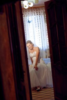 bride waiting for a groom under the veil - look through the doors