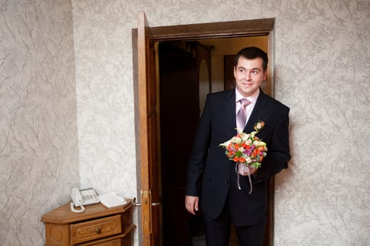 groom with a flower bouquet