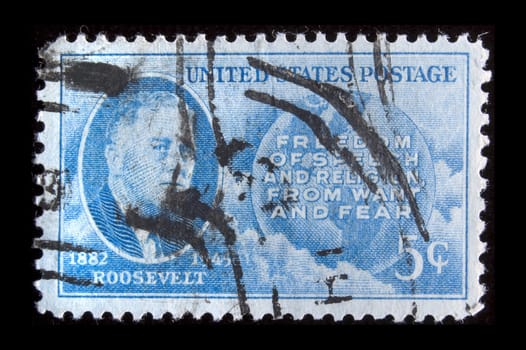 UNITED STATES- CIRCA 1945: Depicting inset of Roosevelt and world, with inscription "Freedom of Speech and Religion from want and Fear" and "1882 Roosevelt 1945", color blue, face value 5 cents, circa 1945
