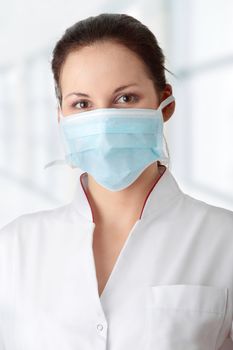 Young nurse in mask , isolated on white background