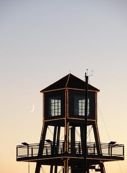 Moon over observation tower on Memphremagog Lake in Magog, Province of Quebec, Canada