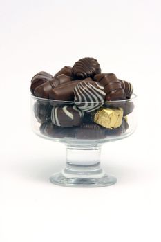 chocolates in crystal bowl on white background food concepts