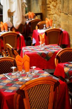 Set tables with tablecloth and glasses on restaurant outdoor patio