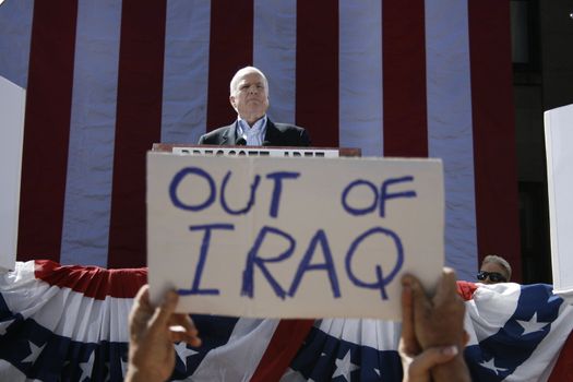 Focus on McCain instead of sign.