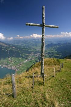 A wooden cross standing on top of Rigi mountain in Switzerland.
