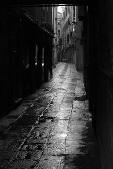 Dark alley in the rainy streets of Venice, Italy.

