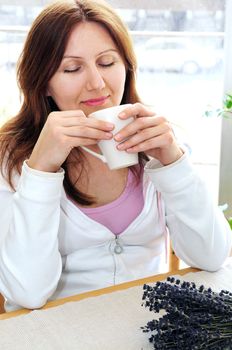 Mature woman relaxing at home holding a cup