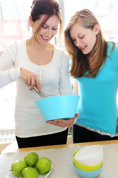 Mother and daughter cooking together at home