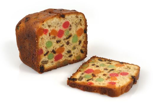 A freshly baked isolated loaf of candied Christmas fruitcake.
