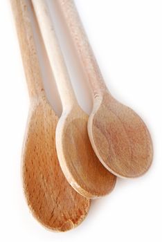 Old wooden cooking spoons isolated on white background