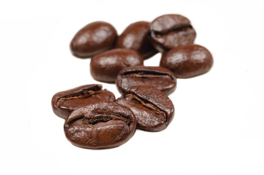 Macro with shallow depth of field of coffee beans on  white background