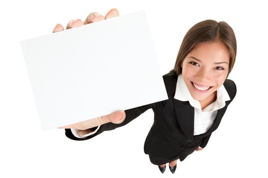 Showing sign - woman holding big business card / paper sign with lots of copy space. Sign and businesswoman face both in focus, High angle full lengh view of happy smiling mixed race Asian / Caucasian female businesswoman isolated on white background.