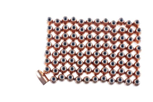 9mm hollow point bullets lined up ready for reloading, with one laying on its side as a odd man out