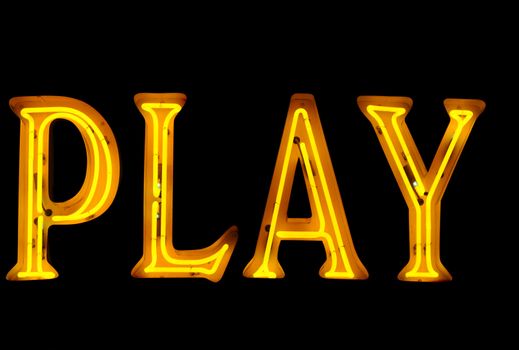 Neon sign with the word "Play" over black