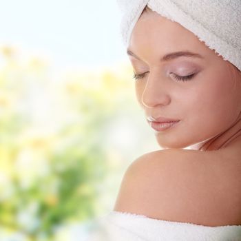 Portrait of young beautiful woman wearing bathrobe