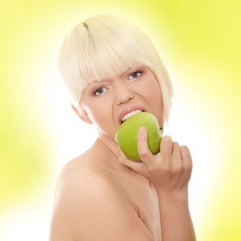 Beautiful blond woman with green apple. Over abstract green background