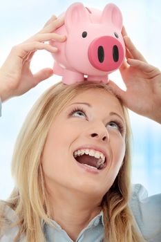 Businesswoman holding piggy bank. Over abstract blue background