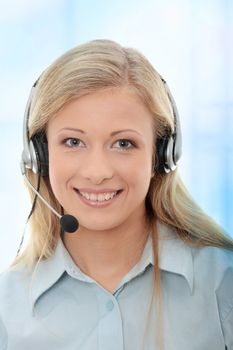 Call center woman with headset.Over abstract blue background