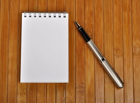pen and notebook on a wooden table