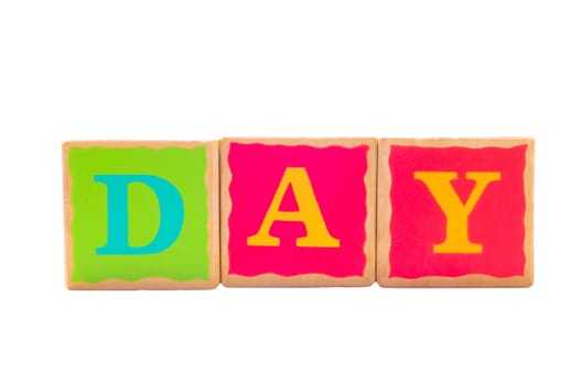 Childrens wooden play alphabet play blocks isolated on a white background spelling the word DAY