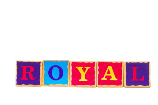 Childrens wooden play alphabet play blocks isolated on a white background spelling the word ROYAL