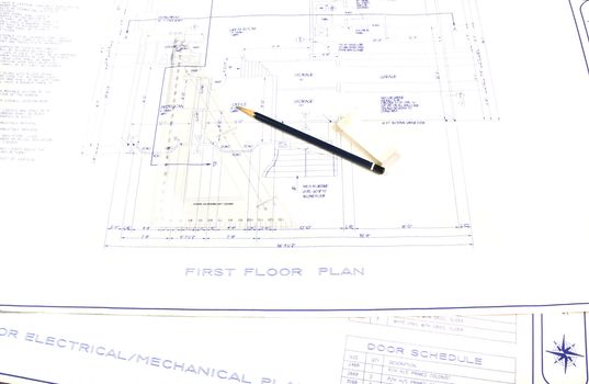 Set of house plans with pencil, eraser and square for blue lining changes