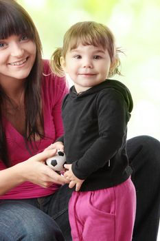 Portrait of a 2 year old girl with young mum