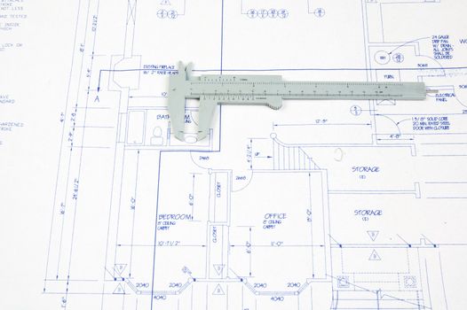 Set of house plans with calipers for determining size against scale