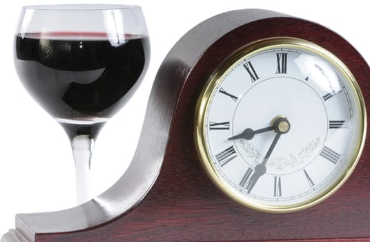 mantle clock and a glass of wine symbolising time for a drink