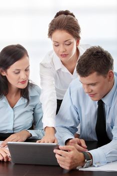 Interracial business team working at laptop in a office