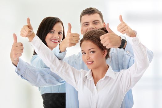 Happy business team with thumbs up