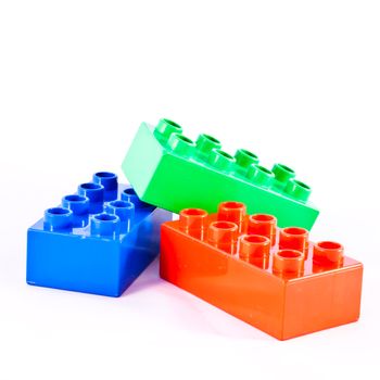 Plastic building blocks on white background. Bright colors.